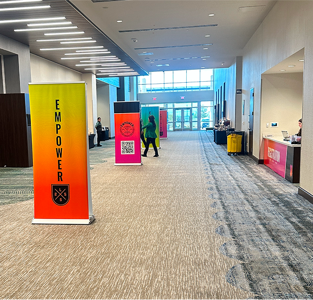 Graphic of a typography specimen showing the alphabet and numerals on top of a dark gray background.